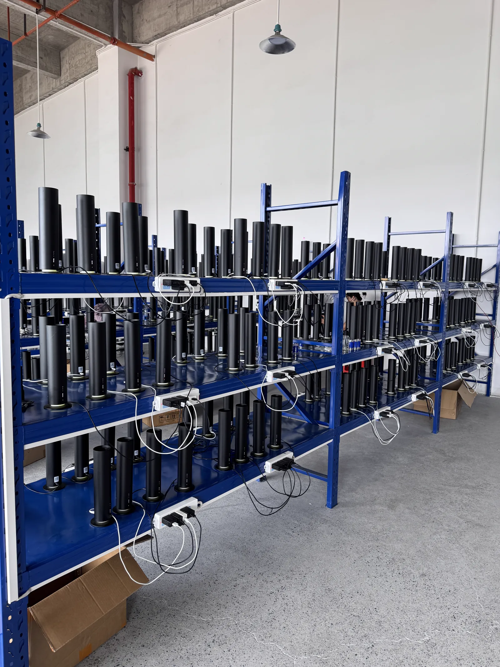 Rows of black scent machines connected to power-on testing racks
